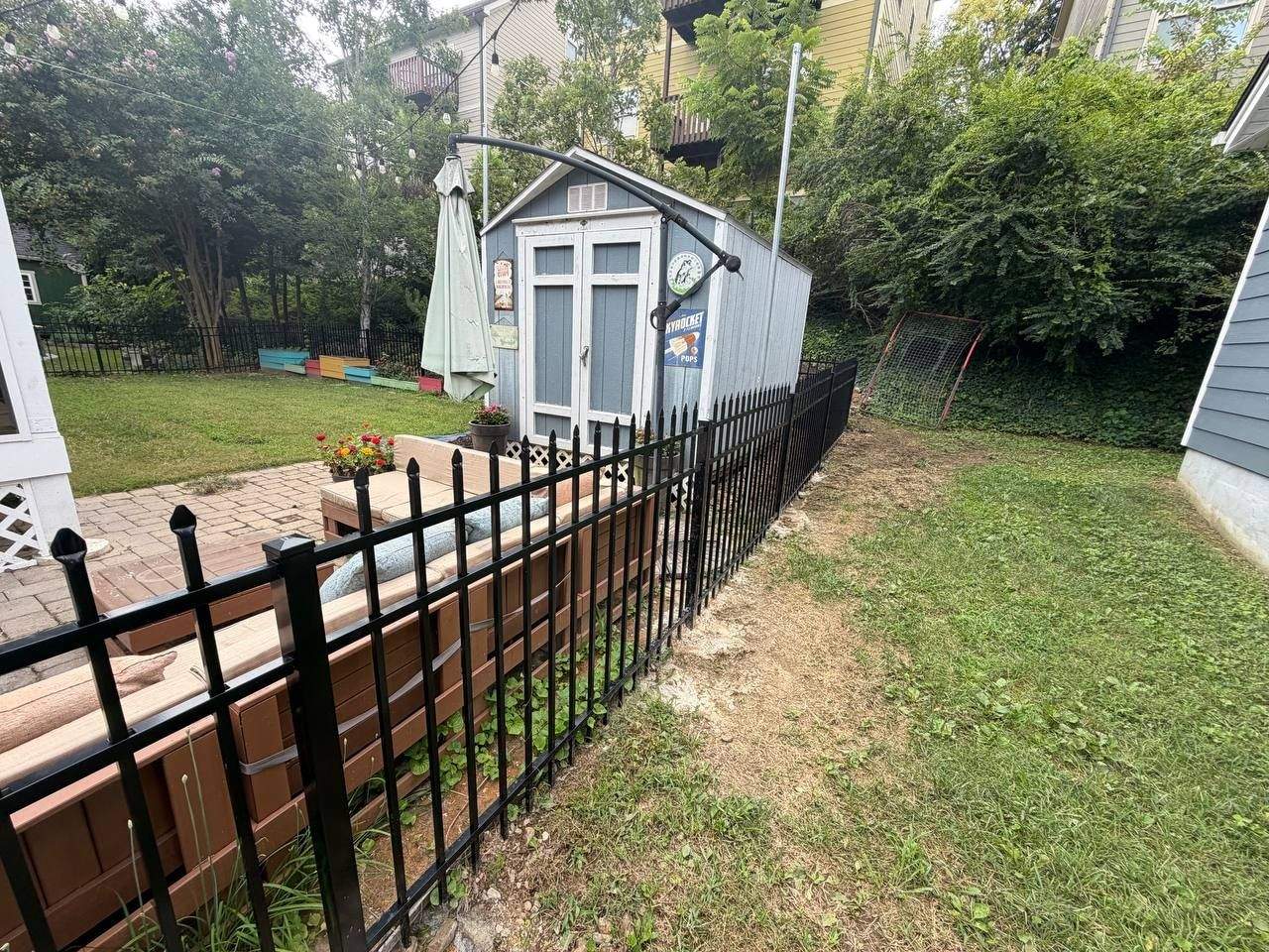 Matching black aluminum gate hardware on a new ornamental fence installation in Chattanooga