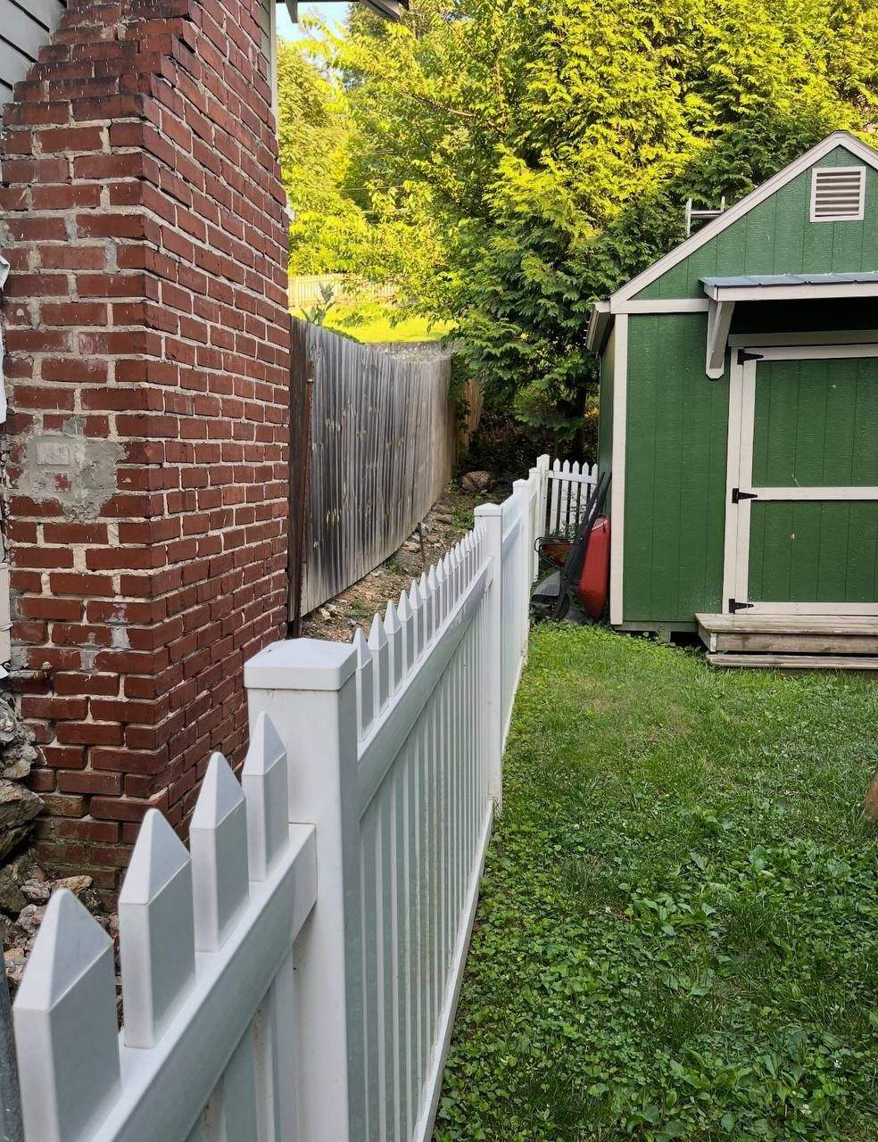 Grade change along the property line before aluminum fence installation in Chattanooga, TN