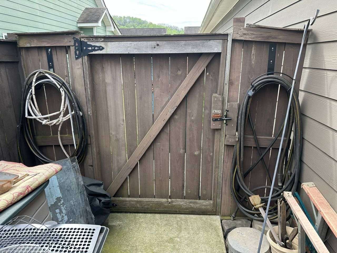 Backyard before a new wood privacy fence and gate installation in Chattanooga, TN