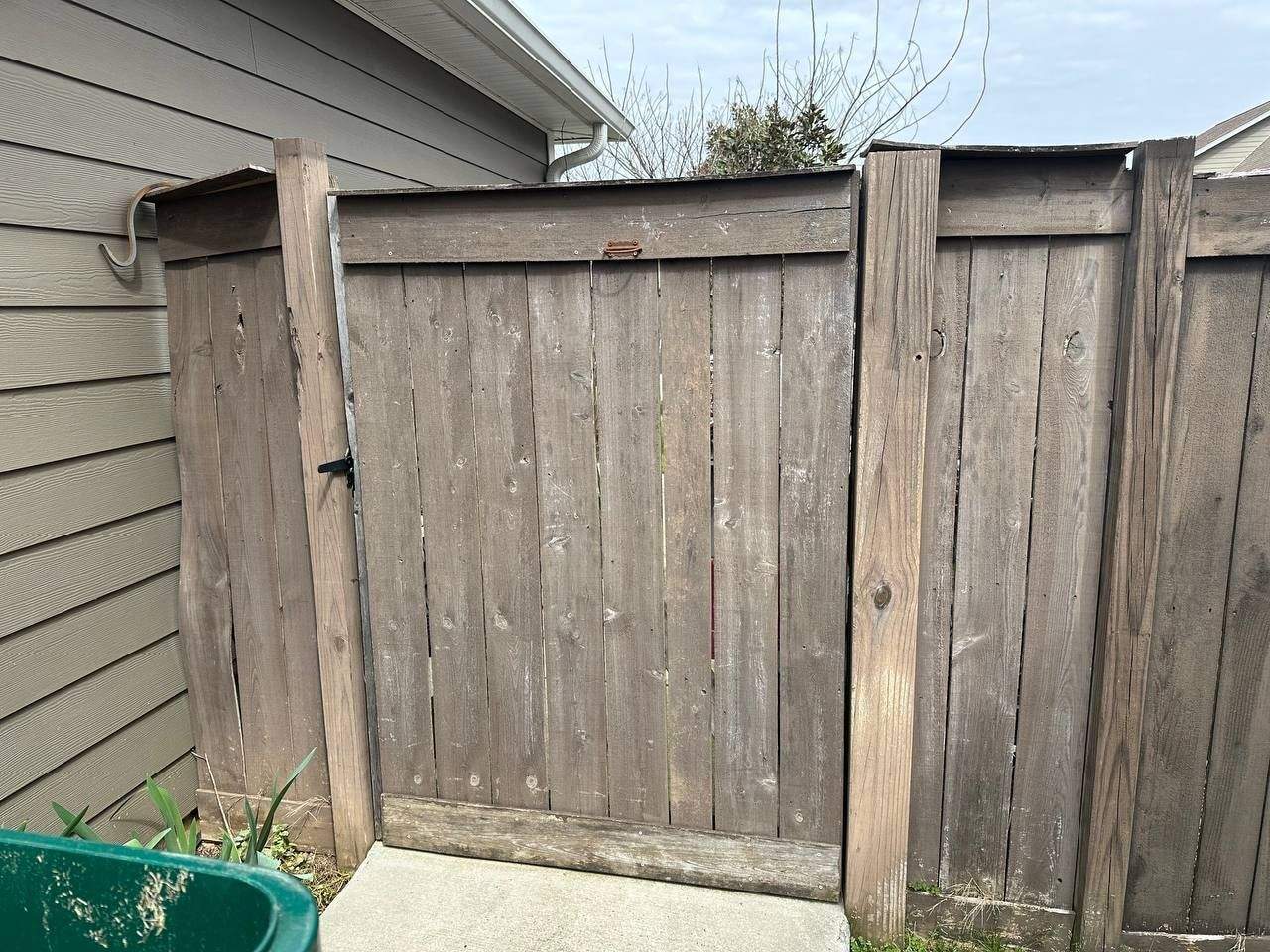 Backyard before fence replacement, showing the old fence line in Chattanooga, TN